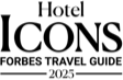 The image is a stylized black silhouette of a cat sitting with its tail curled around its feet.